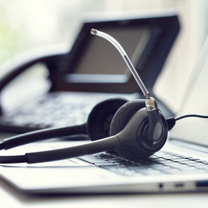 headset-headphones-telephone-and-laptop-in-call-center